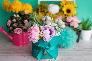 a bouquet of yellow flowers in a vase on a green pastel background. Design of flowers in the Studio.