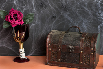 the mystical design of Halloween. A Gothic glass with a skeleton of hands.