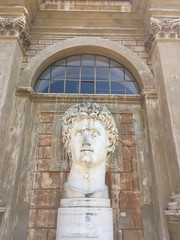 Marble sculpture of a man against the background of an arched window