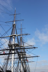 Ship masts against the blue sky