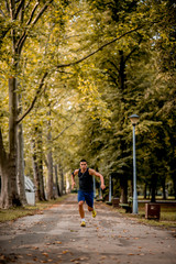Fototapeta na wymiar Young Caucasian man jogging in the park