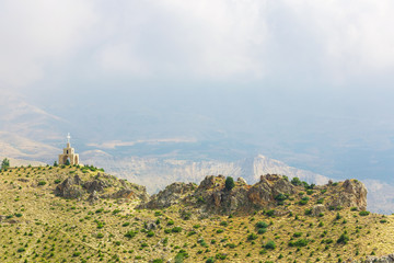 Chapel and cross in the mountains in Lebanon. Panoramic view of the Kadisha Valley. The place of...