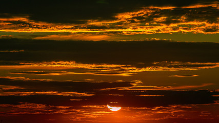 Clouds and sky in the rays of a red sunset