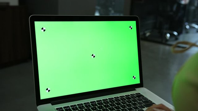 Laptop template with white transparent screen, computer blank display isolated. Metal device. Fingers press keys of the keyboard. Green