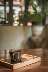 An empty coffee cup with cookie.
