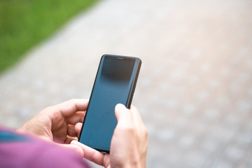 Close-up of men's hand holding a cell phone.