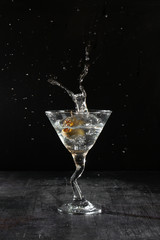 martini with olive splash