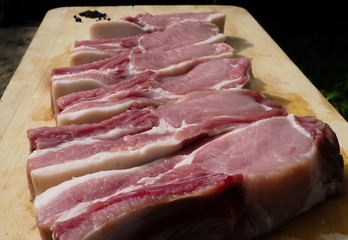 pork steaks on the bone on a wooden table . delicious pork loin steaks on the bone.
