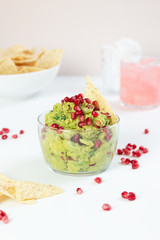 guacamole and chips with pomegranate seeds