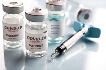 vial of coronavirus vaccine, covid-19, sars, syringe beside