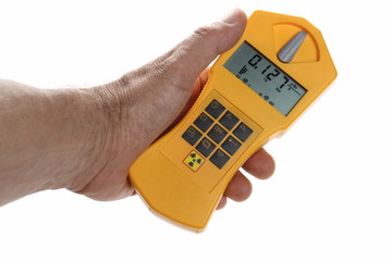 Geiger counter held in hand isolated on white background