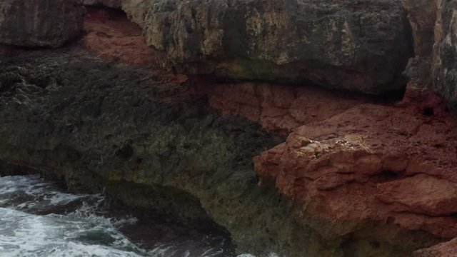AERIAL: Close Up of Waves crashing into Rocks, Cliff, Coast on Sunny Day on Mallorca Island Sunny Weather, Sunshine 
