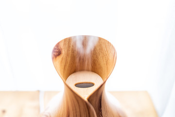 Wooden bamboo essential oil diffuser macro closeup, with steam modern minimalistic minimal health...