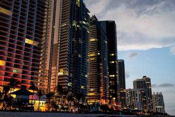 Sunny Isles Beach, apartment condo hotel buildings during dark evening night blue hour illuminated...