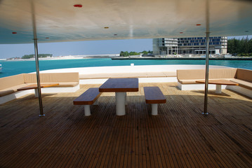 table and benches on the upper deck of the safari ship