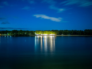 River with open air beach club in the evening afar.