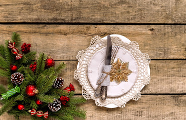 Christmas table setting, menu concept composition, decorated with pine tree branches, spices. Christmas wooden background, made of fir twigs, cones, berries. Flat lay, top view, copy space.