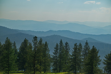 Russia. mountain Altai. Due to forest fires in the Krasnoyarsk territory, the mountains are shrouded in smoke for many kilometers, which makes their contours very expressive.