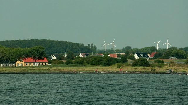 Arrival at the port of Nakskov, behind the typical Danish houses the wind turbines