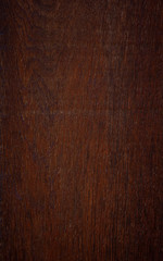 Close-up of an aged dark brown wood board.  Material used in cupboard, closet, furniture or door. High resolution full frame textured background.