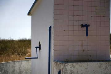 Old hand-operated drinking water fountain in Portugal