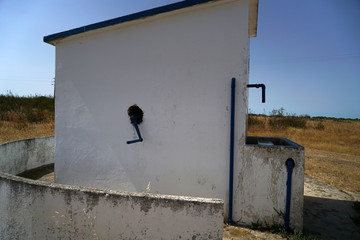 Old hand-operated drinking water fountain in Portugal