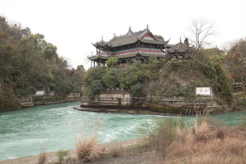 View of ancient irrigation system Dujiangyan Bottleneck Channel and Lidui park in Sichuan, China. Translation on wall text "Bottleneck Channel,  Dragon Taming Pond water cold, lidui park ".