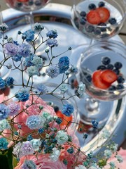 glass of wine with berries and dry flowers