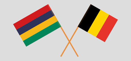 Crossed and waving flags of Mauritius and Belgium