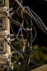 Ragged light poles with many wires and disorganized