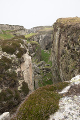 The rocky coastline of the island of Lundy emerging from the fog, The Bristol Channel, Devon, UK