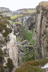 The rocky coastline of the island of Lundy emerging from the fog, The Bristol Channel, Devon, UK