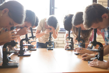 Students using microscopes in science class