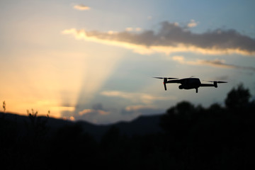 stock photo of drone flying at sunset on the mountain