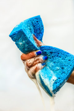 Chinese girl squeezing soapy sponge