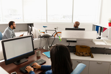 People working at computers in office