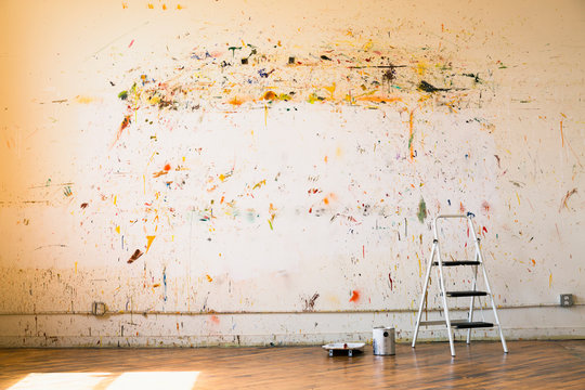 Paint splattered on wall near ladder