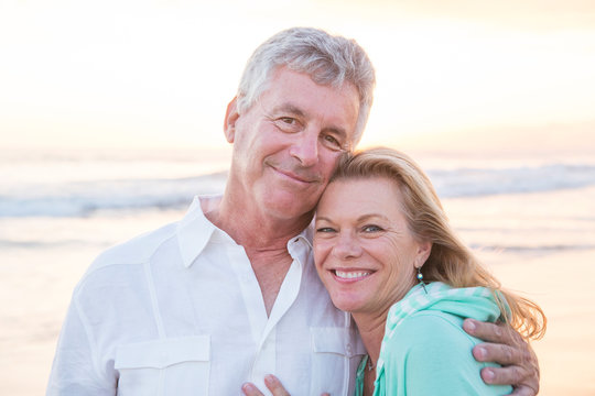 Caucasian couple hugging on beach