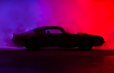 Silhouette of an old fashion muscle car on a red background..