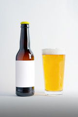 Beer Bottle Mock-Up with glass of lager and foam. Blank Label