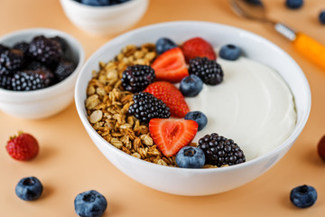 Fresh breakfast with greek yogurt nuts oatmeal granola with berries in a bowl