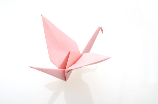 A pink origami paper crane
