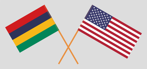 Crossed and waving flags of Mauritius and the USA