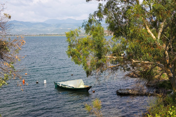 A lone fishing boat moored in a bay of Amvrakkios Gulf, Pigadaki, Amfilochia, Aetolia-Acarnania, Greece