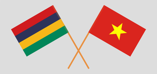 Crossed and waving flags of Mauritius and Vietnam