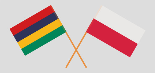 Crossed and waving flags of Mauritius and Poland