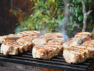 roasting steaks on the fire.flambé.flamber.meat on the bone on the grill.