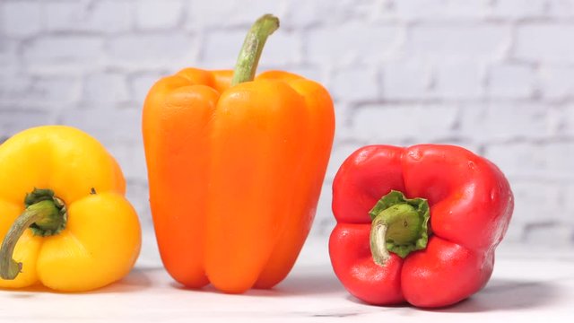 Yellow orange and red capsicum on table 