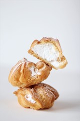 
three round eclairs on a white background