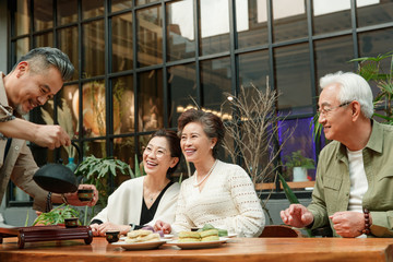 The elderly chat over a cup of tea